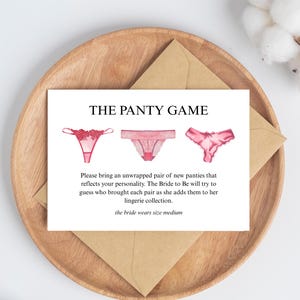May include: A card with the text "THE PANTY GAME" and watercolour illustrations of three pairs of knickers. The card is on a wooden tray with a brown envelope. The text on the card asks guests to bring unwrapped knickers.