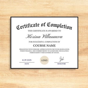 May include: A black-framed certificate of completion on a light wood grain background. The certificate reads "Certificate of Completion" and includes the recipient's name, "Korina Villanueva", and "Course Name". The date is 11/29/2025.