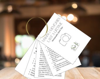May include: A set of white cards with black text and a gold ring. The cards have tips for taking better photos. The text on the cards includes "Making Memories Last a Lifetime" and "Photography Quick Tips".