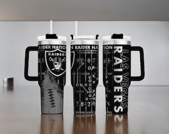 May include: Three black and white tumblers with handles and lids featuring Las Vegas Raiders branding. The designs include the Raiders logo, the text Raider Nation, Las Vegas Raiders, and a football field play diagram with yard line markings.