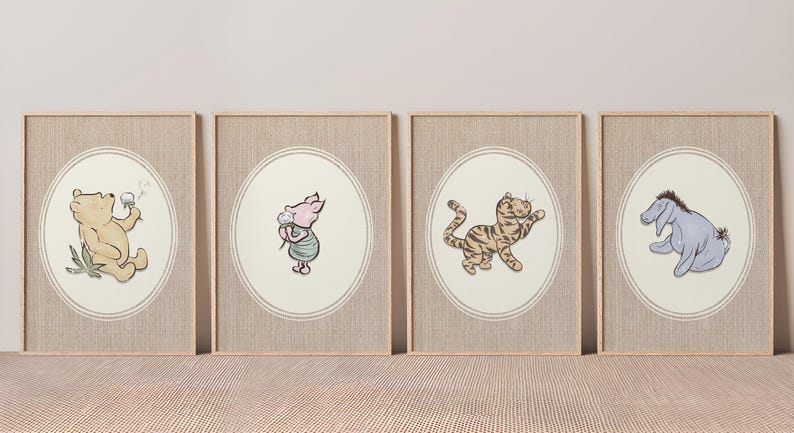 May include: Four framed wall art prints featuring classic illustrations of Winnie the Pooh, Piglet, Tigger, and Eeyore. Each character is centred within an oval border on a textured, light beige background, enclosed in simple light wood frames.