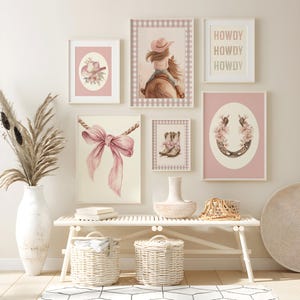 May include: A collection of framed art prints with a cowgirl theme. The prints feature watercolor illustrations of a cowgirl on a horse, a horseshoe with flowers, a pink bow, a cowboy hat, and cowboy boots. The text "HOWDY" is also displayed.