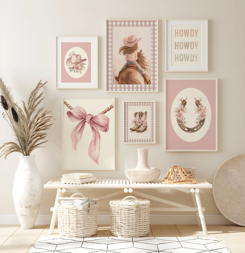 May include: A collection of framed art prints with a cowgirl theme. The prints feature watercolor illustrations of a cowgirl on a horse, a horseshoe with flowers, a pink bow, a cowboy hat, and cowboy boots. The text "HOWDY" is also displayed.