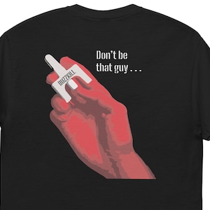 May include: Black t-shirt with the text "Don't be that guy..." in white. The image shows a red hand holding a white object with the word "BUZZKILL" printed on it.