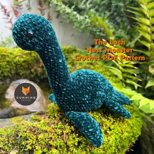 May include: A green crocheted Loch Ness Monster plush toy sitting on a bed of moss. The text "The Loch Ness Monster Crochet PDF Pattern" is written in orange on a white background.