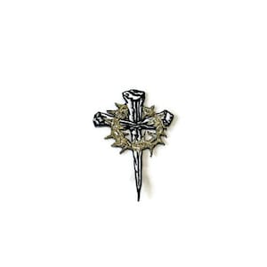 May include: A detailed, black and gold cross design. The cross features a nail, a crown of thorns, and a cross shape. The design is set against a white background, creating a striking contrast. This item is suitable for religious-themed crafts and jewelry.