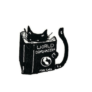 May include: Black and white illustration of a cat reading a book titled "World Domination for Cats".