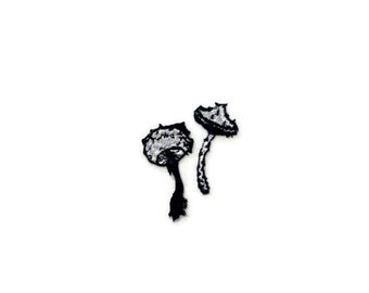 May include: Two black and white embroidered mushroom patches.