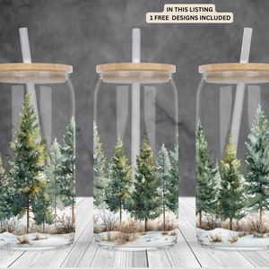 May include: Three clear glass tumblers with bamboo lids and white straws. Each tumbler features a watercolor design of a snowy forest scene with green pine trees.