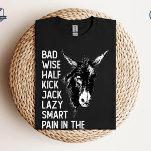 May include: Black t-shirt with a white donkey illustration and the text "Bad Wise Half Kick Jack Lazy Smart Pain in the".