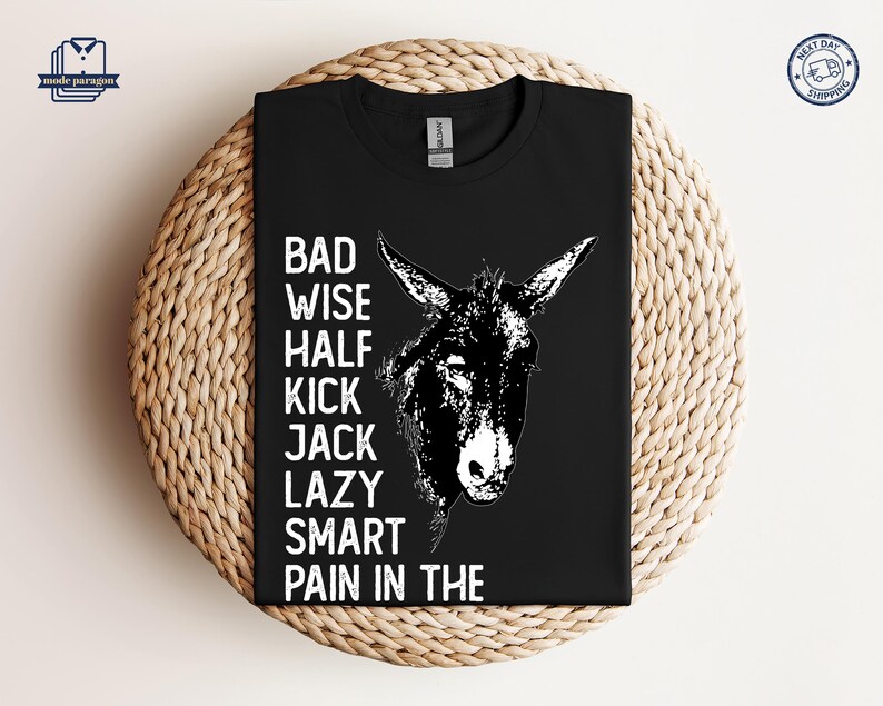 May include: Black t-shirt with a white donkey illustration and the text "Bad Wise Half Kick Jack Lazy Smart Pain in the".