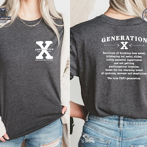 May include: A dark gray t-shirt with a white graphic on the front that says "Generation X" with a large white "X" in the center. The back of the shirt has a white graphic that says "Generation X" with a smaller white "X" in the center and a description of the generation.