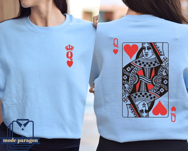 May include: A light blue sweatshirt with a Queen of Hearts playing card graphic on the back and a Queen of Hearts symbol on the front.
