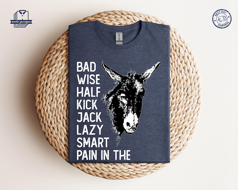 May include: A dark blue t-shirt with a white donkey illustration and the text "BAD WISE HALF KICK JACK LAZY SMART PAIN IN THE".