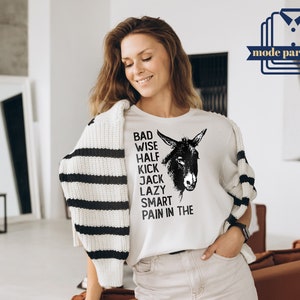 May include: White t-shirt with a black and white illustration of a donkey and the text "Bad Wise Half Kick Jack Lazy Smart Pain in the".