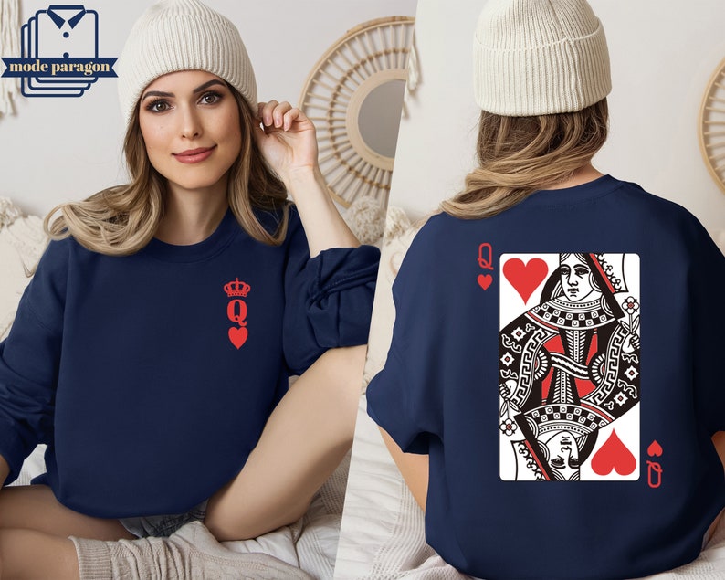 May include: A navy blue sweatshirt with a red queen of hearts playing card design on the back and a smaller red queen of hearts design on the front.