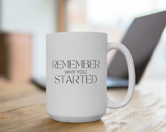 Könnte beinhalten: Eine weiße Keramik-Kaffeetasse mit einer schwarzen Aufschrift, die "Remember why you started" lautet.