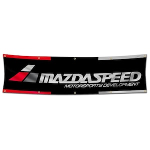 May include: A black banner with the words "MAZDA SPEED MOTORSPORTS DEVELOPMENT" in silver lettering. A red and gray stylized logo is on the left side of the banner.