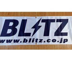 May include: White banner with a blue lightning bolt and the text "BLITZ" in bold blue letters. The text "www.blitz.co.jp" is also in blue letters below the logo.