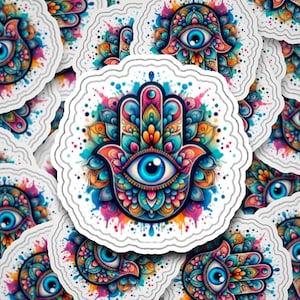 May include: A colorful hamsa hand with an evil eye in the center. The hamsa is surrounded by a watercolor-like design with splashes of color.