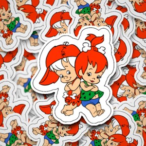 May include: A set of colorful cartoon stickers featuring a boy and girl in caveman outfits. The stickers are white with a black outline and feature a variety of poses.