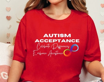 May include: Red t-shirt with the text "AUTISM ACCEPTANCE Celebrate Differences Embrace Acceptance" and a rainbow infinity symbol.