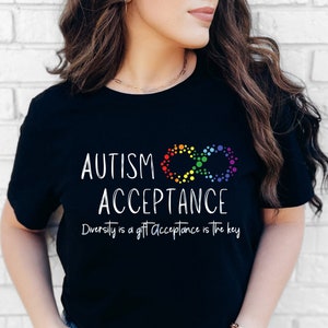 May include: Black t-shirt with the text "Autism Acceptance" and a rainbow infinity symbol. The text below the symbol reads "Diversity is a gift Acceptance is the key."