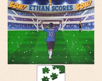 May include: A jigsaw puzzle depicting a soccer stadium scene with a player wearing a blue jersey with the name ETHAN and number 10 on the back. The text ETHAN SCORES and GOAL! appear above the stadium. A small inset shows four loose green puzzle pieces.