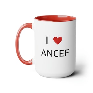 May include: White ceramic mug with a red interior and handle. The mug features the text "I ♥ ANCEF" in black, with a red heart symbol. The mug is designed for hot beverages.