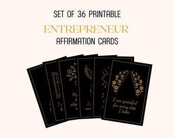 May include: A set of 36 black affirmation cards for entrepreneurs. Each card has gold text and illustrations. The cards are fanned out, with the top card reading "I am grateful for every step I take."