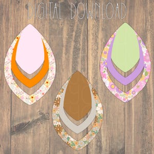 Puede incluir: Tres diseños de pendientes en forma de lágrima. Cada pendiente presenta un borde con estampado floral con un centro de color liso. Los pendientes son en rosa y naranja, marrón y gris, y verde y morado.