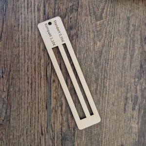Pu&ograve; includere: Un righello di legno con due fessure per misurare. Il righello ha il testo "Standard 0.95&euro;" e "Kompakt 1.10&euro;" stampato su di esso.