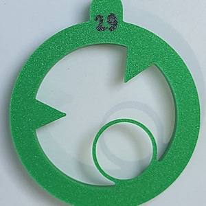 May include: Green plastic circle with a number "29" on the top and a smaller circle cut out in the center.
