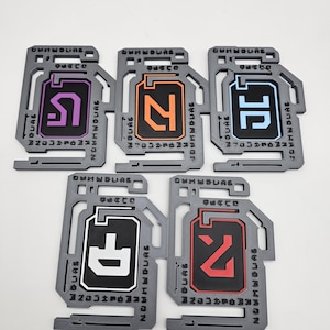 May include: A white ceramic mug with a black handle and the text "But First, Coffee" in a black, bold font. The mug is on a white surface.