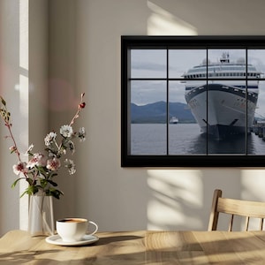 May include: A framed print depicting a cruise ship at a pier, seen through a window. The black-framed artwork is on a beige wall, with a wooden table, a vase of flowers, and a cup of coffee in the foreground. A wooden chair is also visible.