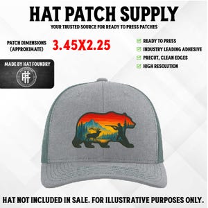 May include: A grey trucker cap with a patch depicting a bear silhouette with a hunter, deer, and mountain scene. The patch dimensions are approximately 8.76 x 5.72 cm. The text "HAT PATCH SUPPLY" is at the top.