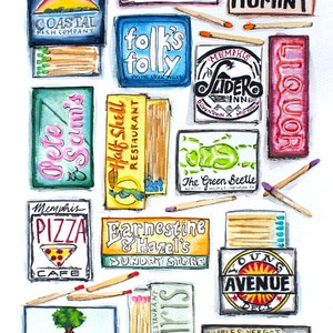 May include: Watercolor painting of matchbox labels with various Memphis, Tennessee businesses. The labels feature colorful illustrations and text, including "Huey's Blues, Brews + Burgers", "Hog and Hominy", "Folk's Folly Prime Steak House", "The Green Beetle", "Memphis Pizza Cafe", "Farnestine & Hazel's Sundry Store", "Young Avenue Deli", "Brookhaven Pub & Grill", "Pete & Scum's", "Half Shell Restaurant", "Memphis Slider Inn Downtown Mid-Town", "Liquor", and "Charles Vergo's Rendezvous Charcoal Ribs in Downtown Memphis since 1948".