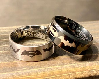 Personalized Titanium superhero bat inspired ring, inside and outside wrap around various symbols through the years.