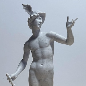 May include: A gray statue of a male figure, possibly Mercury, with a winged helmet and holding a staff. The statue is standing on a rectangular base. The figure is nude and has detailed musculature.