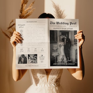 May include: A person holding a newspaper titled "The Wedding Post" with the headline "Happily Ever After!" and the text "Lauren & Jacob are getting married!" The newspaper features a black and white photo of a couple kissing. The person is wearing a white wedding dress.