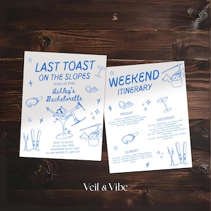 May include: Two white invitation cards with blue text and illustrations on a wooden background. The left card reads "Last Toast on the Slopes" for Ashley's Bachelorette. The right card is a weekend itinerary.