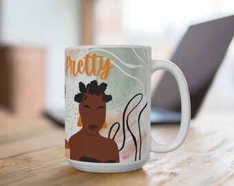 May include: White ceramic mug featuring a stylized illustration of a Black woman with the word "Pretty" in orange script. The design includes abstract shapes in green, white, and peach, with black line art. The mug has a large handle.
