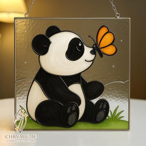 May include: Stained glass panel featuring a panda bear with black and white fur, sitting on green grass. An orange butterfly rests on the panda's nose. The panel is framed in gold and includes the text "CHRYALUME STAINED GLASS PATTERNS".