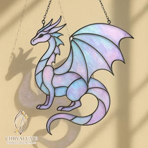 May include: A stained glass dragon in shades of lavender, blue, and white, with black outlines. The dragon is hanging from a chain. The logo "CHRYALUME STAINED GLASS PATTERNS" is visible at the bottom.