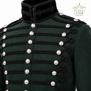 May include: A dark green jacket featuring a high black velvet collar, black cord braiding, and silver-toned buttons arranged in rows. The garment displays the text Rovigo Classic in the upper right corner, showcasing a structured design.