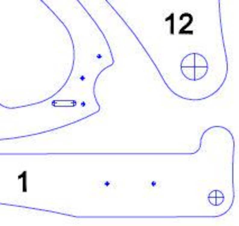 May include: A detailed, top-down view of a laser-cut wooden template with blue outlines. The template is composed of several interconnected pieces, with the numbers "1" and "12" visible. The design includes various shapes, holes, and cutouts, suggesting a construction or craft project.