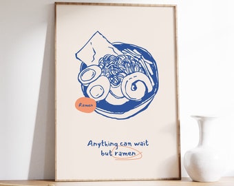 Puede incluir: Una impresión enmarcada con una ilustración azul de un tazón de fideos ramen. El texto "Anything can wait but ramen" está escrito debajo de la ilustración.