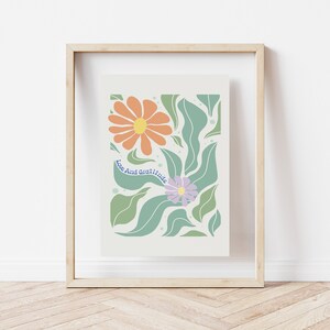 May include: A framed print with a floral design featuring orange and purple flowers with green leaves. The text "Love And Gratitude" is written in blue on a white background.