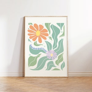 May include: A framed print with a floral design featuring orange and purple flowers with green leaves. The text "Love and Gratitude" is written in blue on the print.