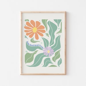 May include: A printable art print with a floral design featuring orange, yellow, purple, and green flowers and leaves. The text "Love And Gratitude" is written in blue cursive.